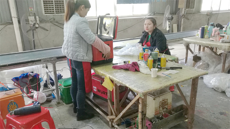Manufacturing partner staff inspecting metal cooler products